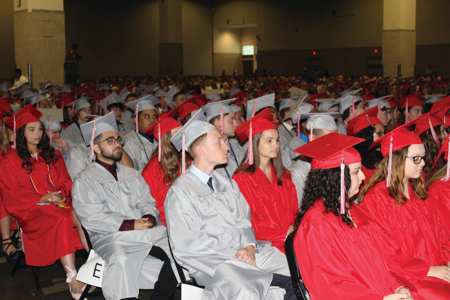 A SEA OF RED AND GRAY: The graduates filled the venue with their cap and gown colors on Saturday as they awaited their moment to cross the stage.